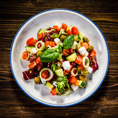 Greek salad on wooden background 