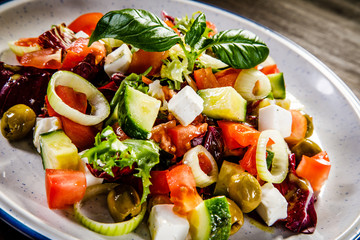 Greek salad on wooden background 