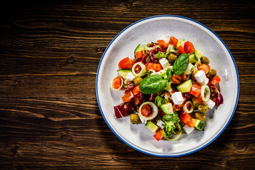Greek salad on wooden background 