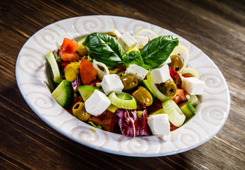 Greek salad on wooden background 