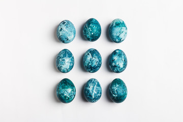 Easter eggs row isolated painted by hand in blue color on white background