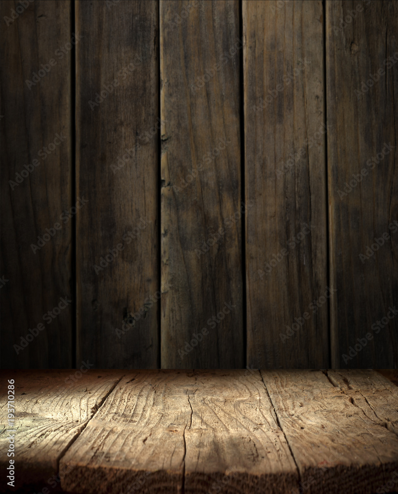 Wall mural old wood table top with smoke in the dark background.