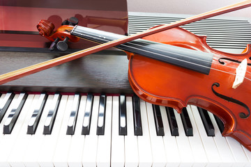 Violin on piano keyboard. Music instrument. Art and music background.