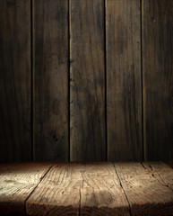 Old wood table top with smoke in the dark background.