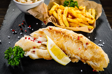 Fish dish - fried fish fillet with french fries and vegetables