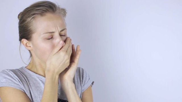 Young beautiful woman coughing