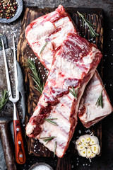 raw meat ribs on wooden cutting board