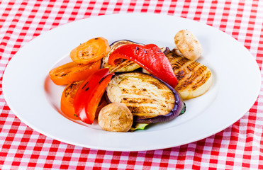 Different grilled vegetables on white plate. Close up