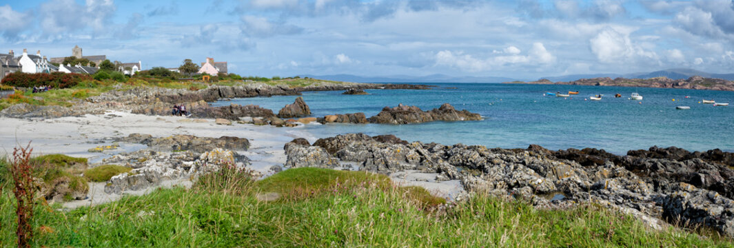 A view of the beachfront and turquoise water on the Isle of Iona in Soctland.