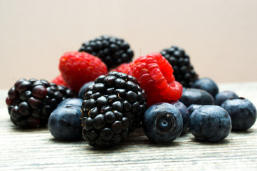Raspberry, blackberry and blueberry on the wooden board

