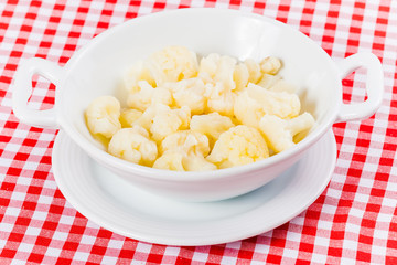 Boiled cauliflower in white plate. Close up