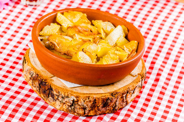 Fried potatoes with onion in ceramic bowl. Close up