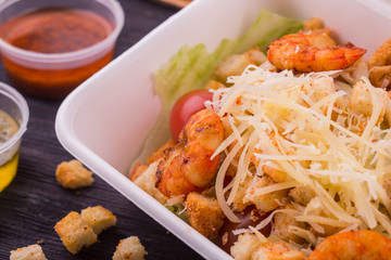 Cheese the parmesan sprinkled on tiger shrimps and croutons
