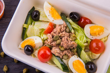 Beef with capers, boiled egg, tomatoes, a cucumber, olives and lettuce leaves