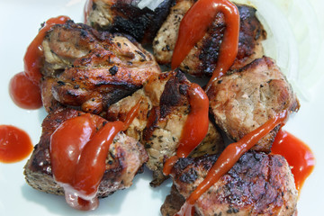 Fried pieces of meat with ketchup