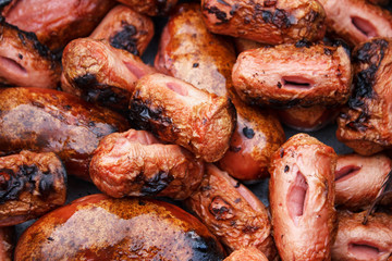 Roasting sausages on the fire, close-up view