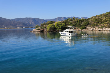 Summer time a beautiful yacht anchoring in Love bay Poros island Greece.