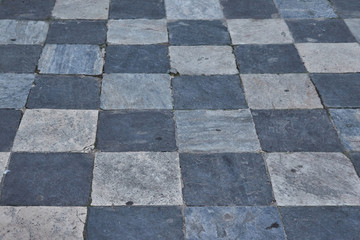 Stone pavement of black and white squares in Toledo, Spain. Texture or background