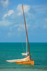 A small Bahamian C-Class sailboat waiting at anchor for the next regatta race on Little Farmer's...