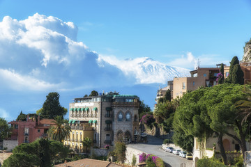 Fototapeta premium Beautiful ancient Taormina city with the volcano Etna at the background. Province of Messina. Sicily, Italy.