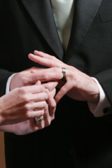 Obraz na płótnie Canvas Groom puts on Wedding Ring, Shallow depth of Field