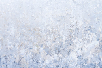 Winter frosty patterns on the frozen ice window