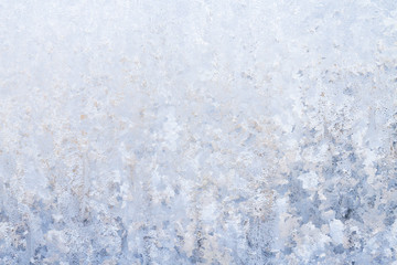 Winter frosty patterns on the frozen ice window