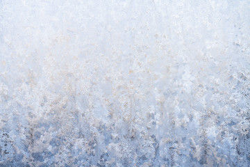 Winter frosty patterns on the frozen ice window