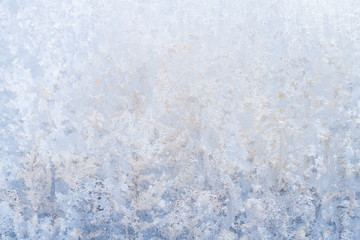 Winter frosty patterns on the frozen ice window
