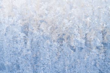 Fototapeta na wymiar Winter frosty patterns on the frozen ice window