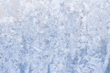 Winter frosty patterns on the frozen ice window