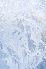 Winter frosty patterns on the frozen ice window