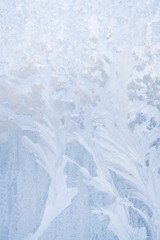 Winter frosty patterns on the frozen ice window