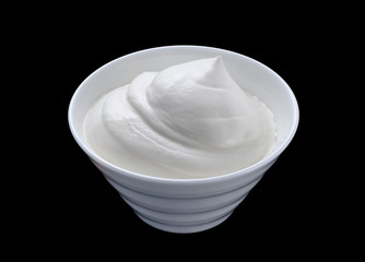 Sour cream in white bowl isolated on black background