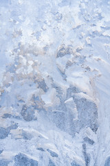 Winter frosty patterns on the frozen ice window