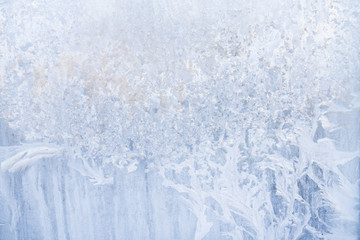 Winter frosty patterns on the frozen ice window
