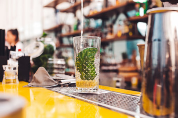 Bartender makes a cocktail.