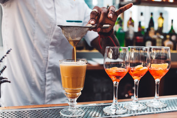 Bartender makes a cocktail.