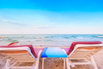 Beach chairs sand beach with cloudy blue sky
