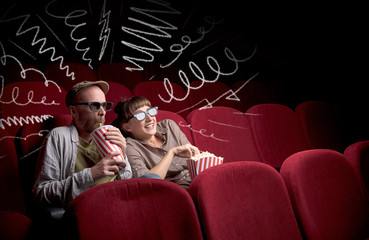 Naklejka premium Cute couple in cinema watching movie