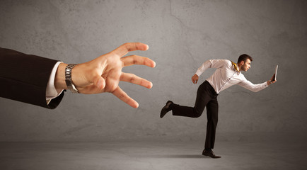 Businessman running from hand