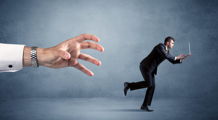 Businessman running from hand