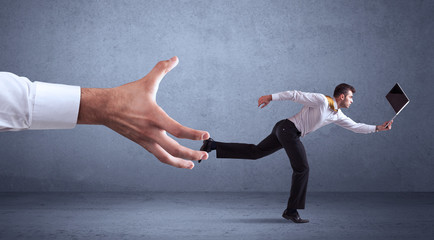 Businessman running from hand