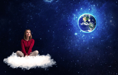 Fototapeta na wymiar Woman sitting on cloud looking at planet earth