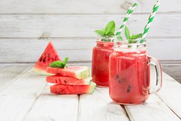 Summer healthy watermelon smoothie on white wooden background. Rustic style. Close up.