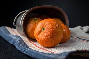 Oranges spilling from canteen cup