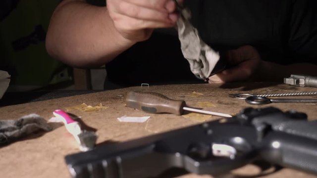 Firearm dis-assembly for cleaning and safety check of handheld gun. 