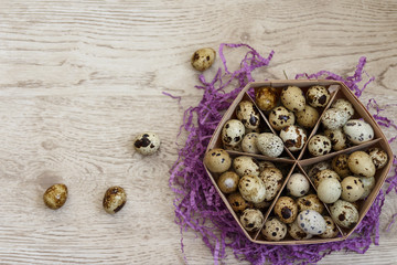 a basket with quail eggs stands on a violet decor