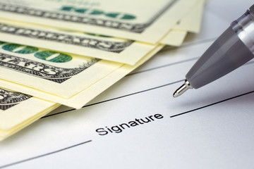 put a signature on an contract waiting to be signed money dollars