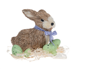 Funny little rabbit among Easter eggs in velour grass isolated on white